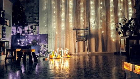 Christmas and New Year decoration. Room decorated with lights and candles.の写真素材