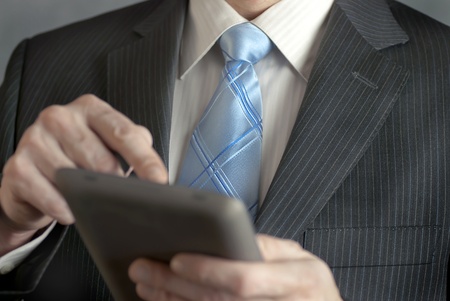 A close-up shot of a businesman using a tablet computer.の写真素材