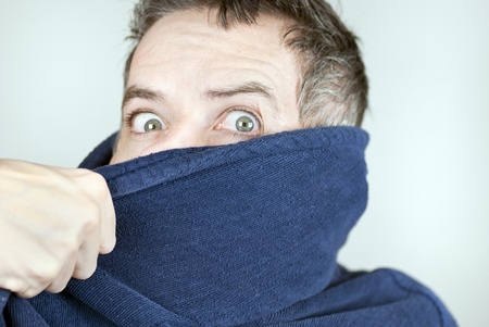 Close-up of a man wearing a housecoat being pulled off camera.の写真素材