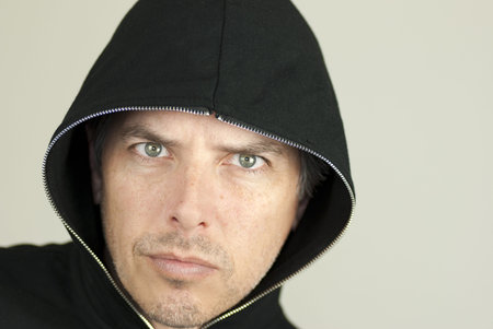 Close-up of an intense man looking to camera.