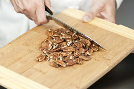 Close-up of a chef preparing pecans.