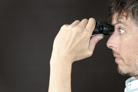 Close-up of a man trimming his monobrow with a full sized electric razor.