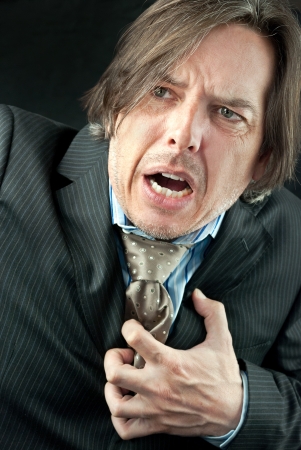 Close-up of a businessman experiencing a heart attack の写真素材