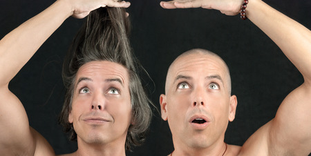 Close-up of a man with long hair held up, next to the same man with a newly shaved head の写真素材