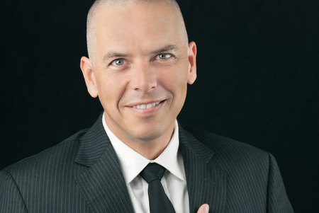 Close-up of a happy bald man smiling to camera の写真素材