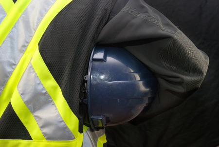 Close-up of a construction worker holding his hardhat under his arm の写真素材