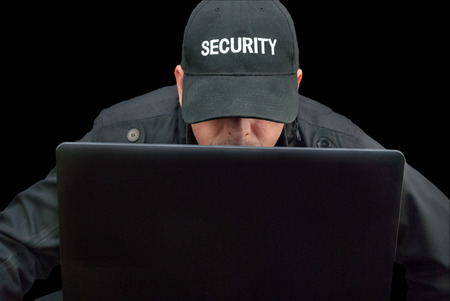 Close-up of security working on a laptop, brim down の写真素材