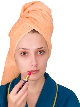 A young woman putting make up on her face の写真素材