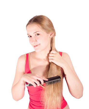 Girl combing her long hair. Isolated on whiteの写真素材