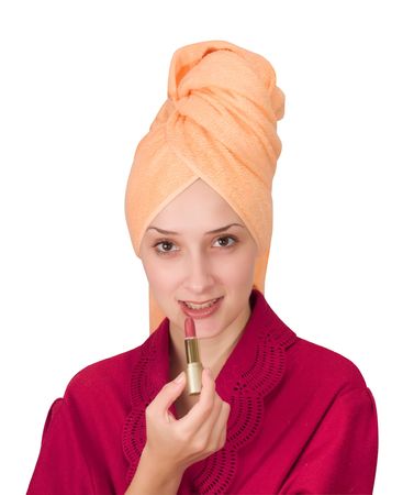 young woman putting make up on her face. Isolatedの写真素材