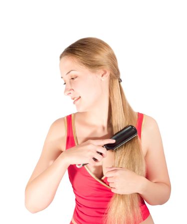 Girl combing her long hair. Isolated on whiteの写真素材