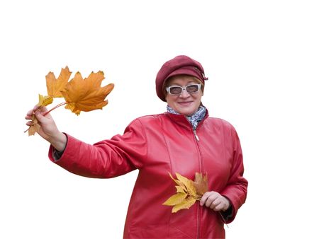 Smiling old lady in red holds an Autumn  leavesの写真素材