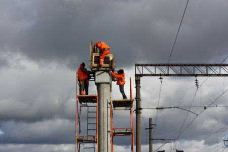 Top men in orange working on concrete piles の写真素材