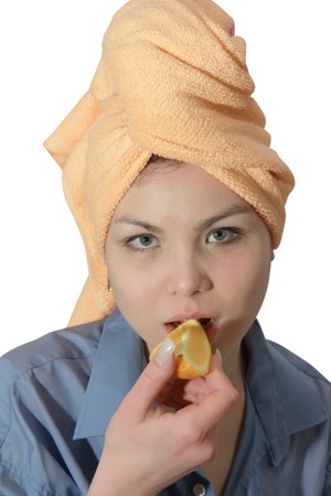 Girl eating a orange. Isolated on whiteの写真素材
