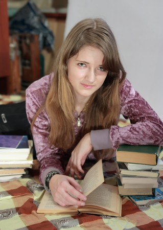 beauty teenager girl with books at homeの写真素材