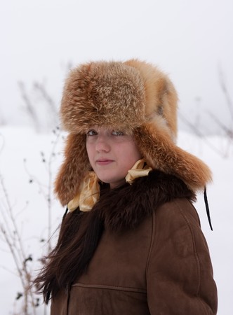 woman in sheepskin and fox cap in winter parkの写真素材