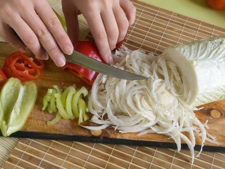 Slicing of pepper and Green goods on a cook-tableの写真素材