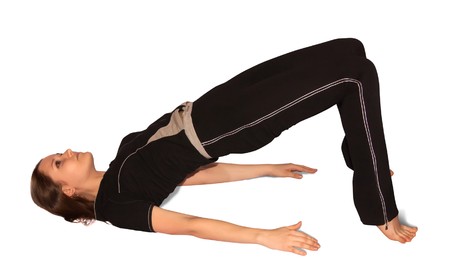 fit brunette in black sportswear practicing yoga over whiteの写真素材