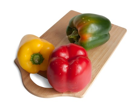  pepper on cutting board. Isolated over whiteの写真素材