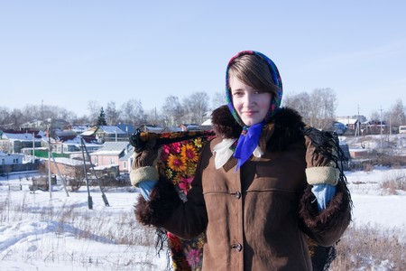 girl in russian traditional clothes against  winter landscapeの写真素材