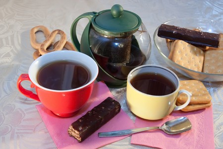 caps of tea and cookie on cook-tableの写真素材