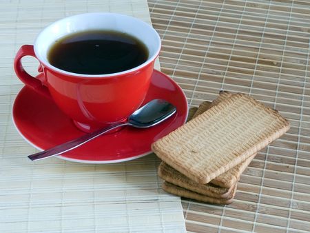 red cap of tea and cookie on cook-tableの写真素材
