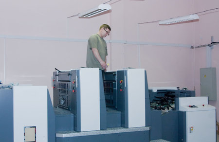Printer working at his new offset machine