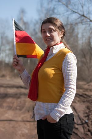 Girl is holding the germany flag outdoorの写真素材