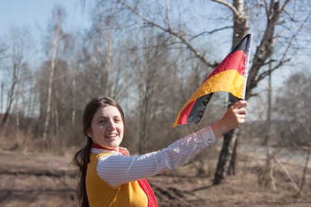 Girl is holding the germany flag outdoorの写真素材