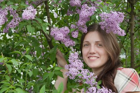 portrait of young woman in the blossoming gardenの写真素材