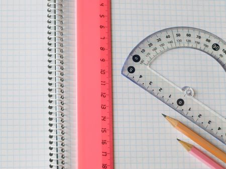 ruler and pencils on squared sheet of a copybookの写真素材