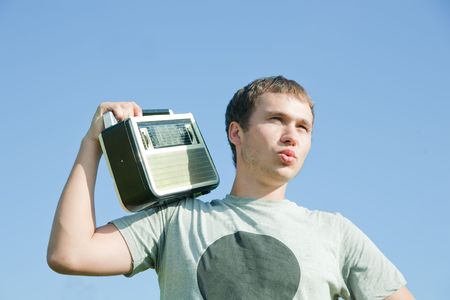 man with old radio receiver at natureの写真素材