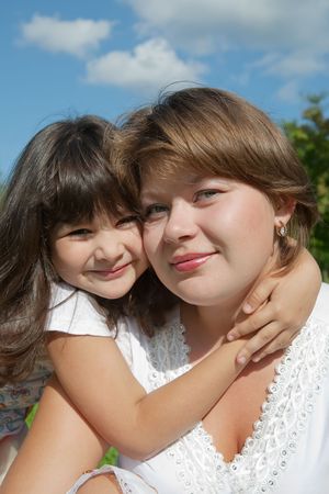 Happy mother with her daughter against natureの写真素材