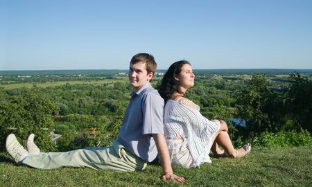 happy couple smiling outdoors against blue skyの写真素材