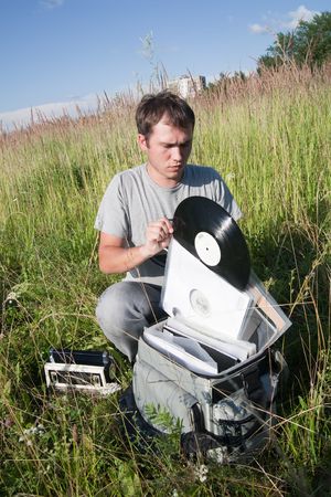 male dj with disk and radio at natureの写真素材