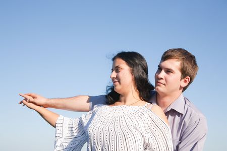 portrait of a young man and his girlfriend stretching their hand together の写真素材