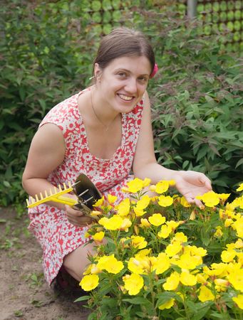 Beautiful young woman in the yard gardeningの写真素材