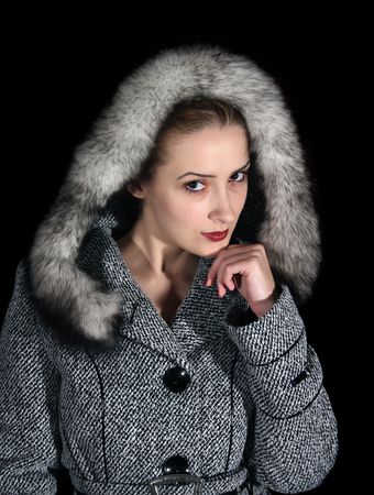 woman in gray coat on black backgroundの写真素材