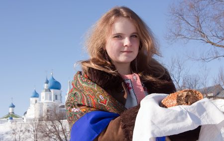 Smiling girl in russian traditional kerchief with loafの写真素材