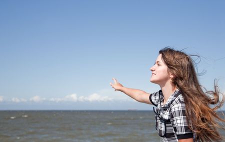 Girl on mooring against sea and skyの写真素材