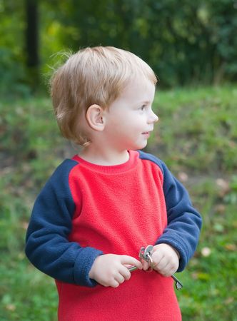 Portrait or young adorable child against park の写真素材
