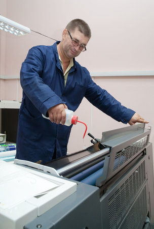 Printer working at his modern offset machine