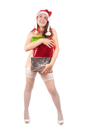 Sexy brunette woman in a santa hat sitting naked with Christmas giftsの写真素材