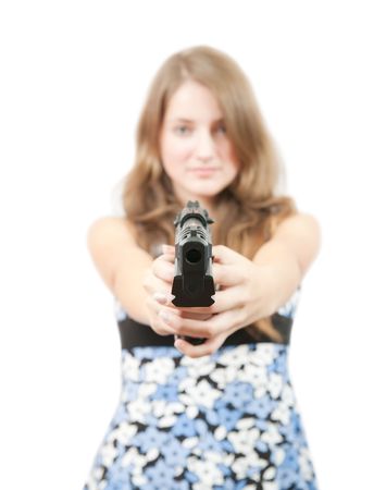 Brunette girl in blue dress with gun. Focus on gun onlyの写真素材