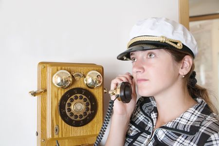 Portrait of girl is speaking by retro wooden phoneの写真素材