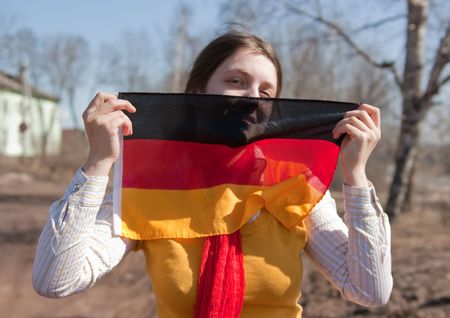 Girl is holding the germany flag outdoorの写真素材