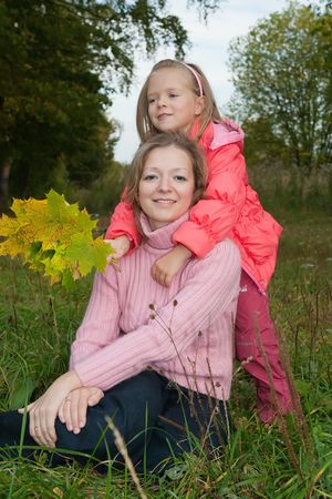 Happy mother with her daughter against natureの写真素材