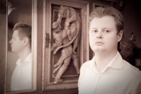 Retro portrait of man against vintage furnitureの写真素材