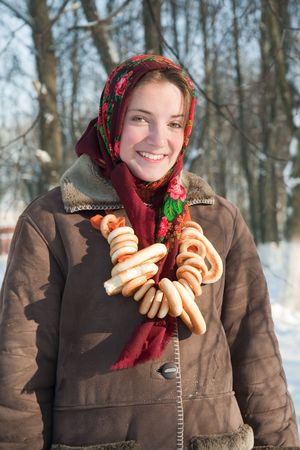 Smiling girl in russian traditional kerchief with round cracknelの写真素材