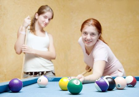  women playing billiards. Focal point on ballの写真素材